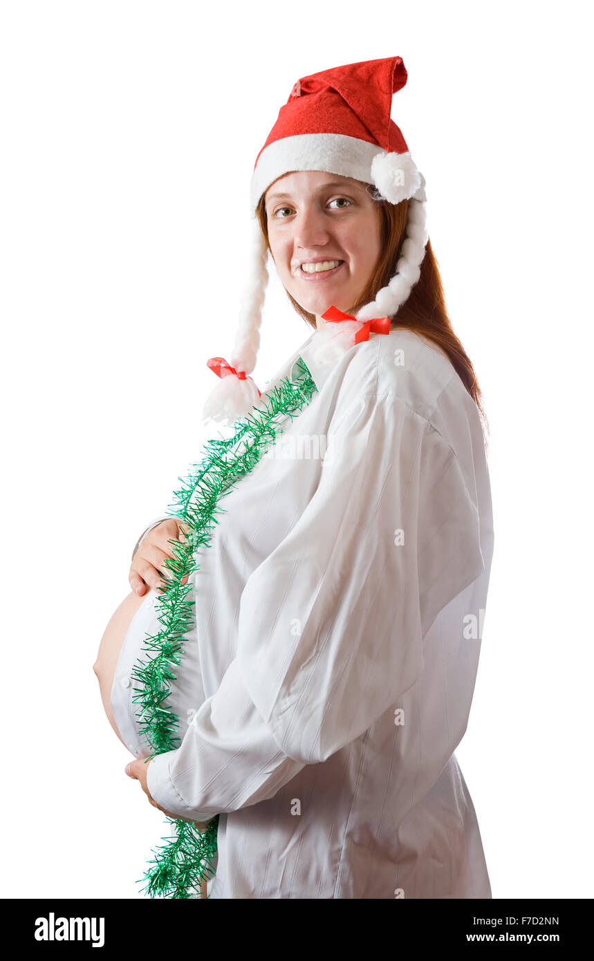 Schwangere Frau in weißem Hemd und Weihnachtsmütze. Isoliert auf weiß Stockfoto