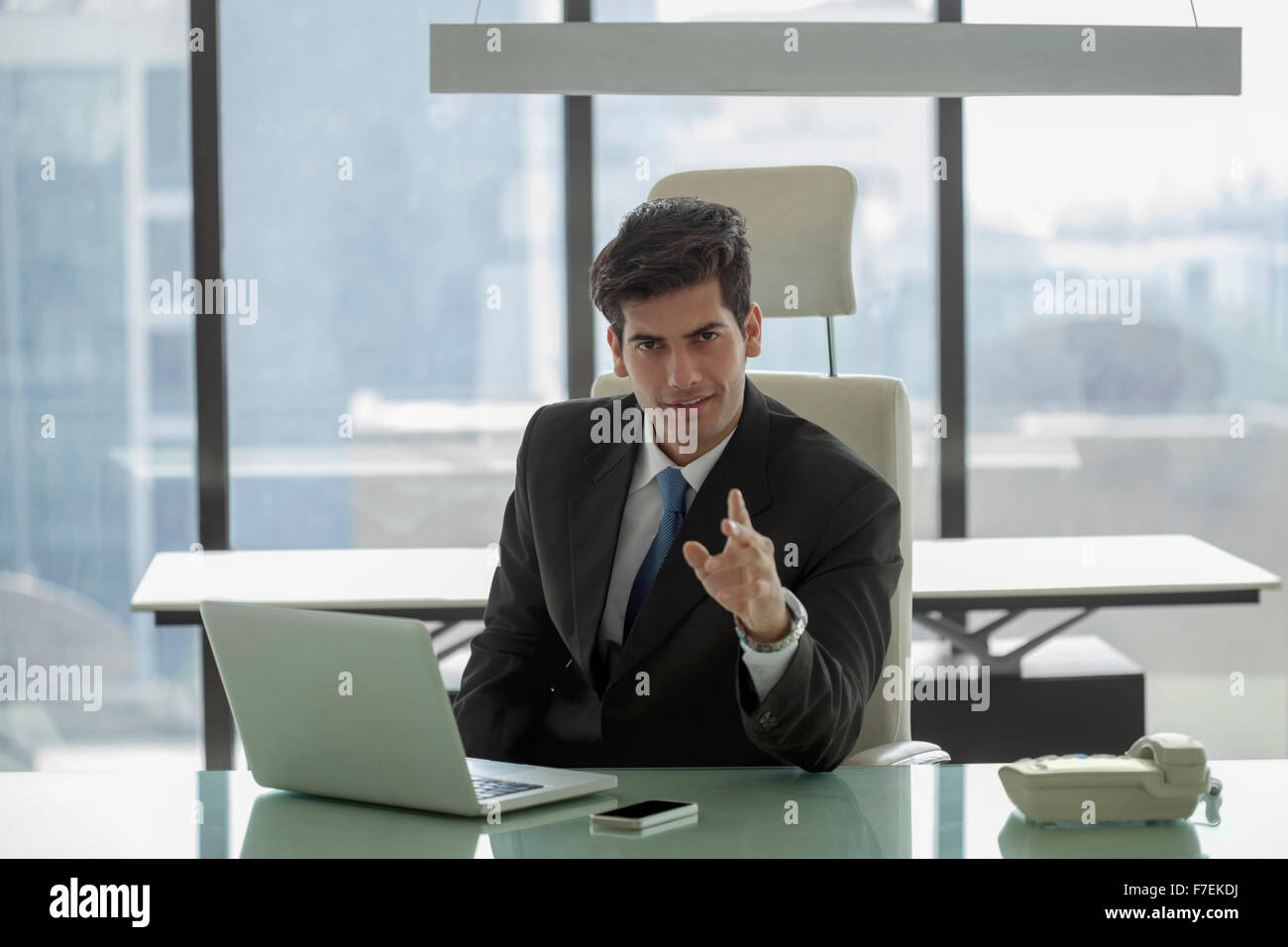 Indien, Geschäftsmann am Schreibtisch streckt seine Hand in Richtung Kamera Stockfoto