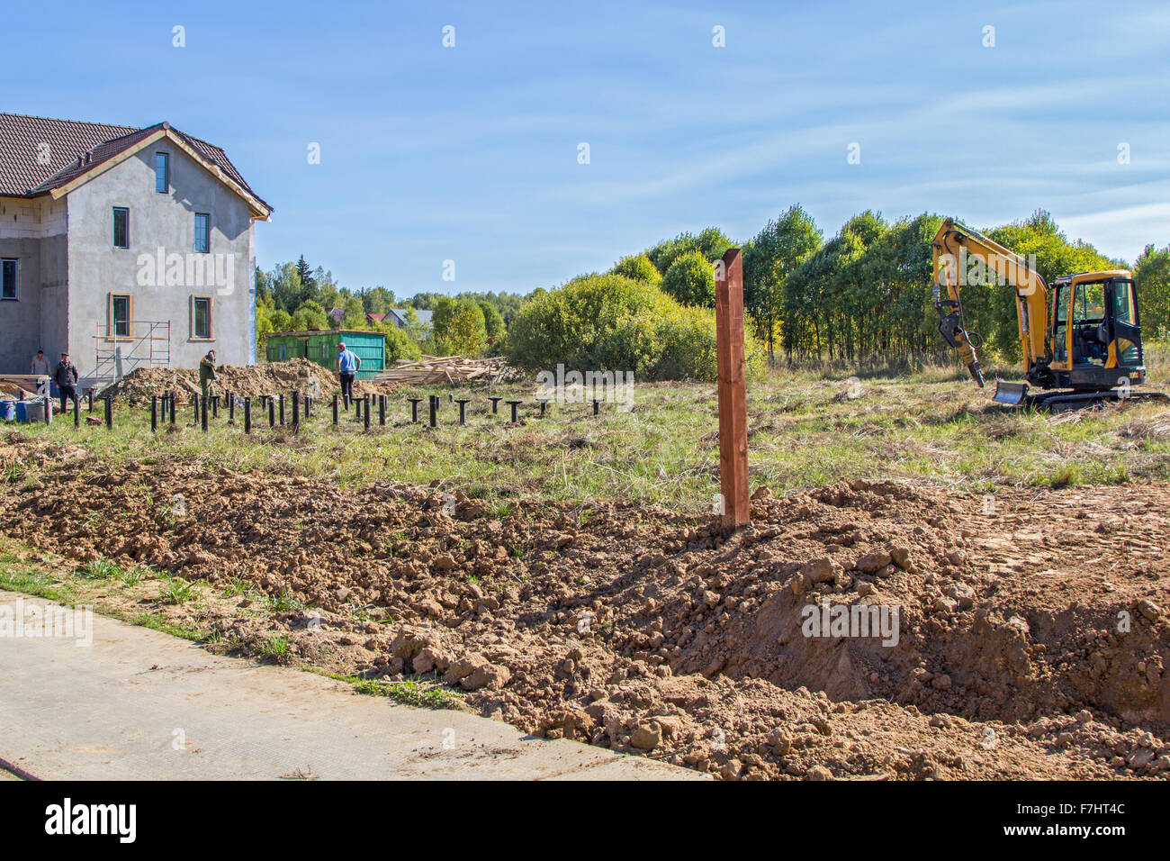 Arbeiter installieren Pfahlgründungen auf Baustelle Stockfoto