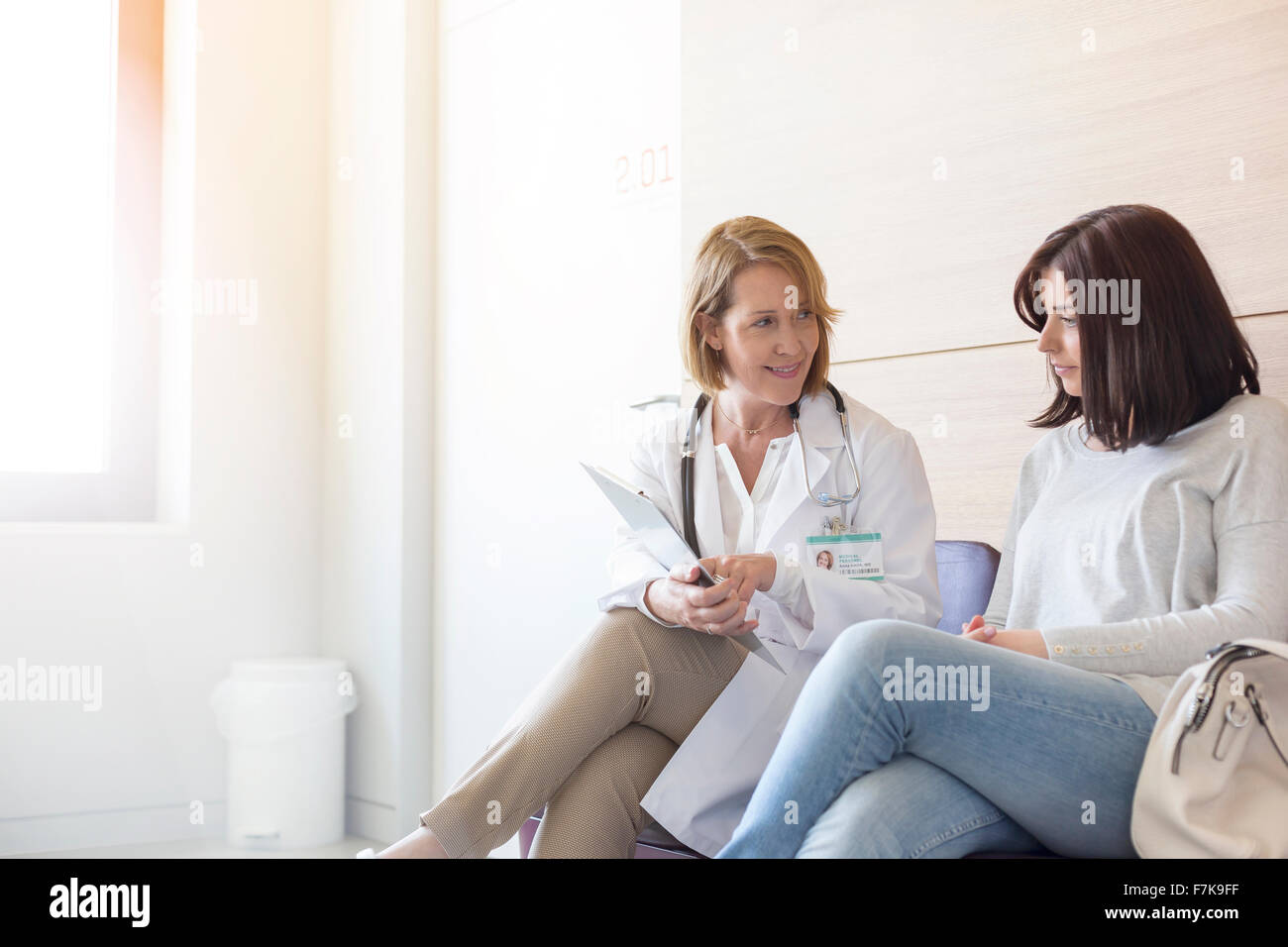 Arzt und Patient, die Überprüfung der Krankenakte im Klinik-lobby Stockfoto