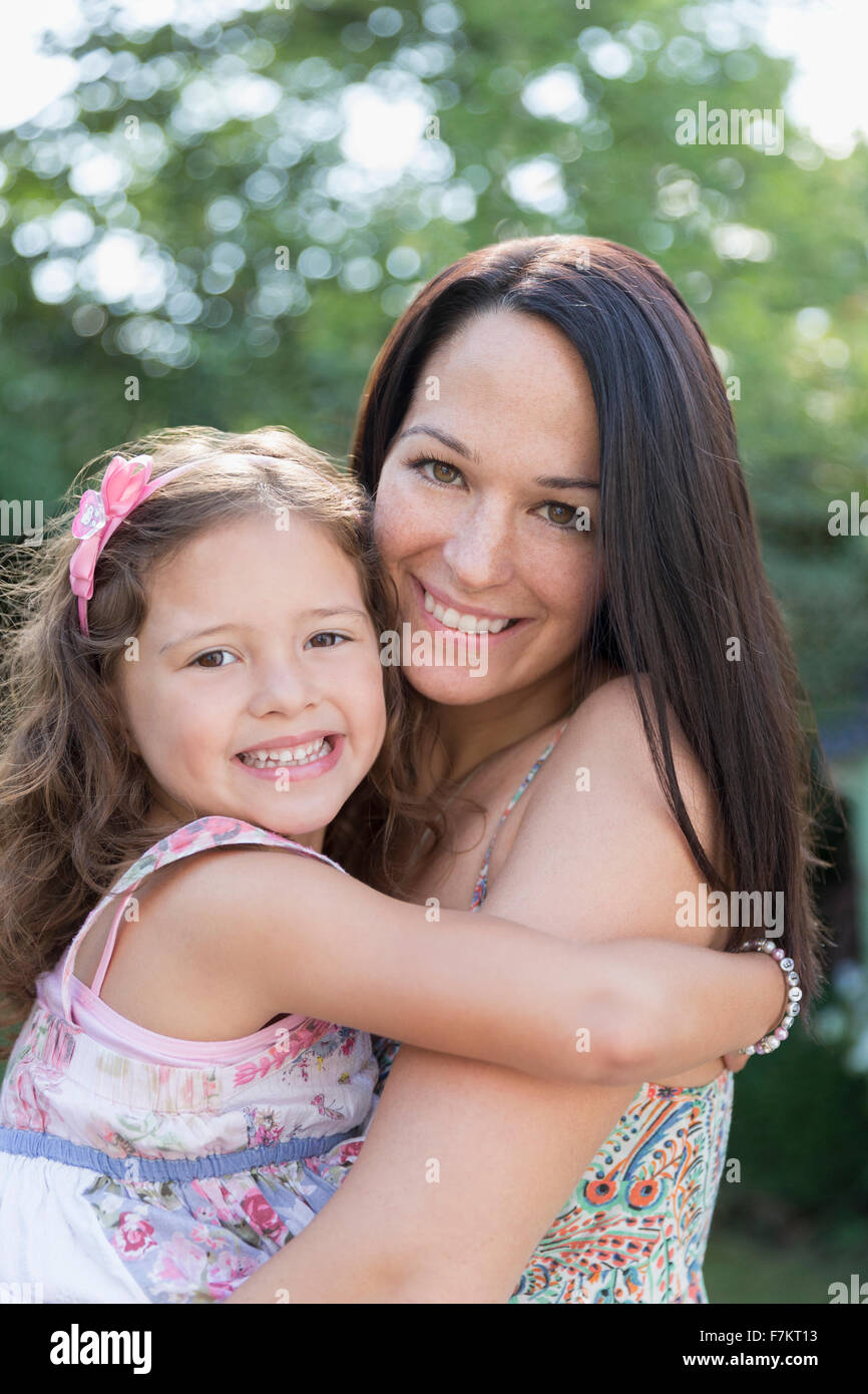 Porträt lächelnde Mutter-Holding-Tochter Stockfoto