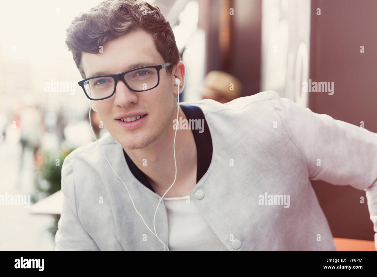 Porträt, Lächeln Mann mit Brille, die Musik über Kopfhörer hören Stockfoto