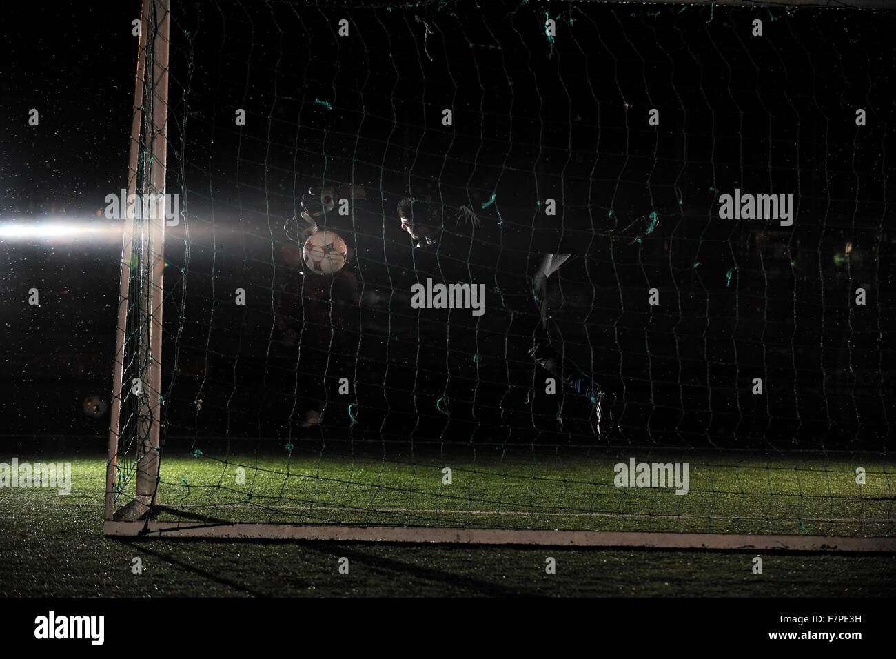 Fußball Fußball-Torwart in der Nacht mit Regen Stockfoto