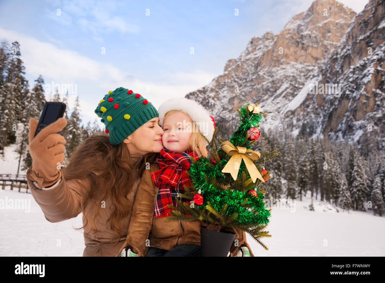 Winter im Freien auf Weihnachten kann Märchen-Maker für Kinder oder auch Erwachsene. Glückliche Mutter und Kind mit Weihnachtsbaum Stockfoto