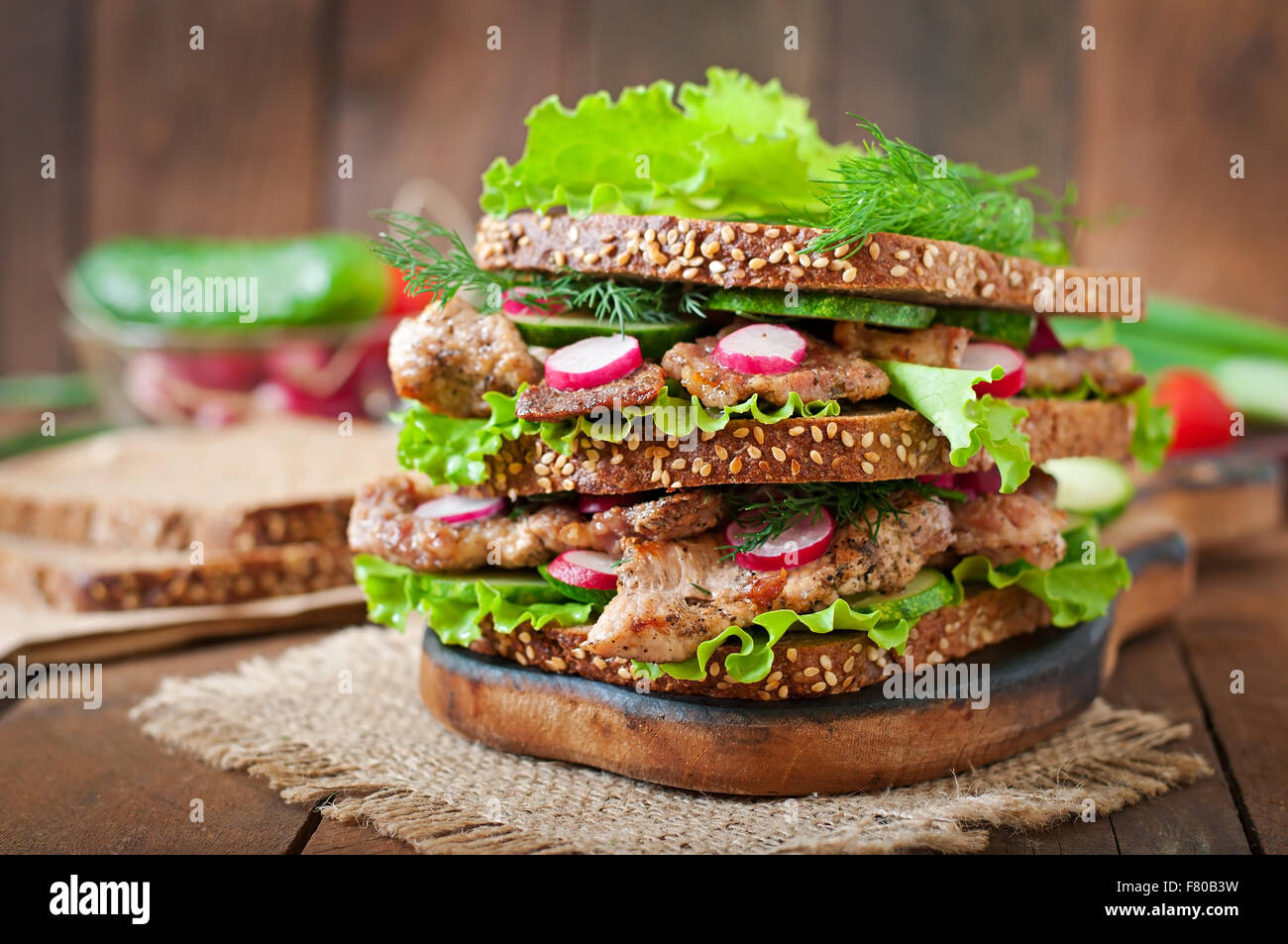 Sandwich mit Fleisch, Gemüse und Scheiben Graubrot Stockfoto