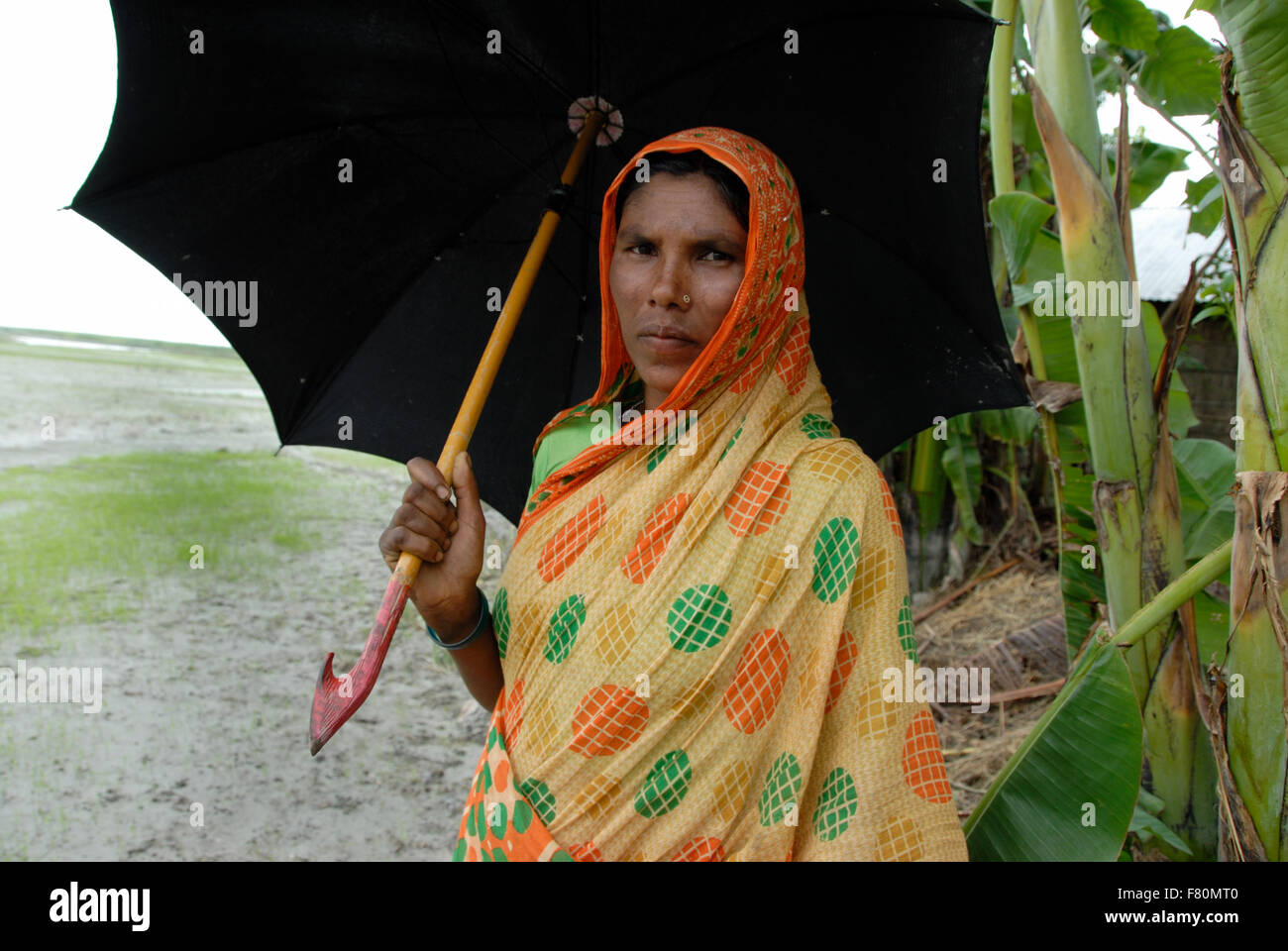 Besuch bei Flut betroffenen Norden Bangladesch. Dorf-Frau mit Regenschirm. Karigam Bezirk, rund 400 km von Dhaka Stockfoto