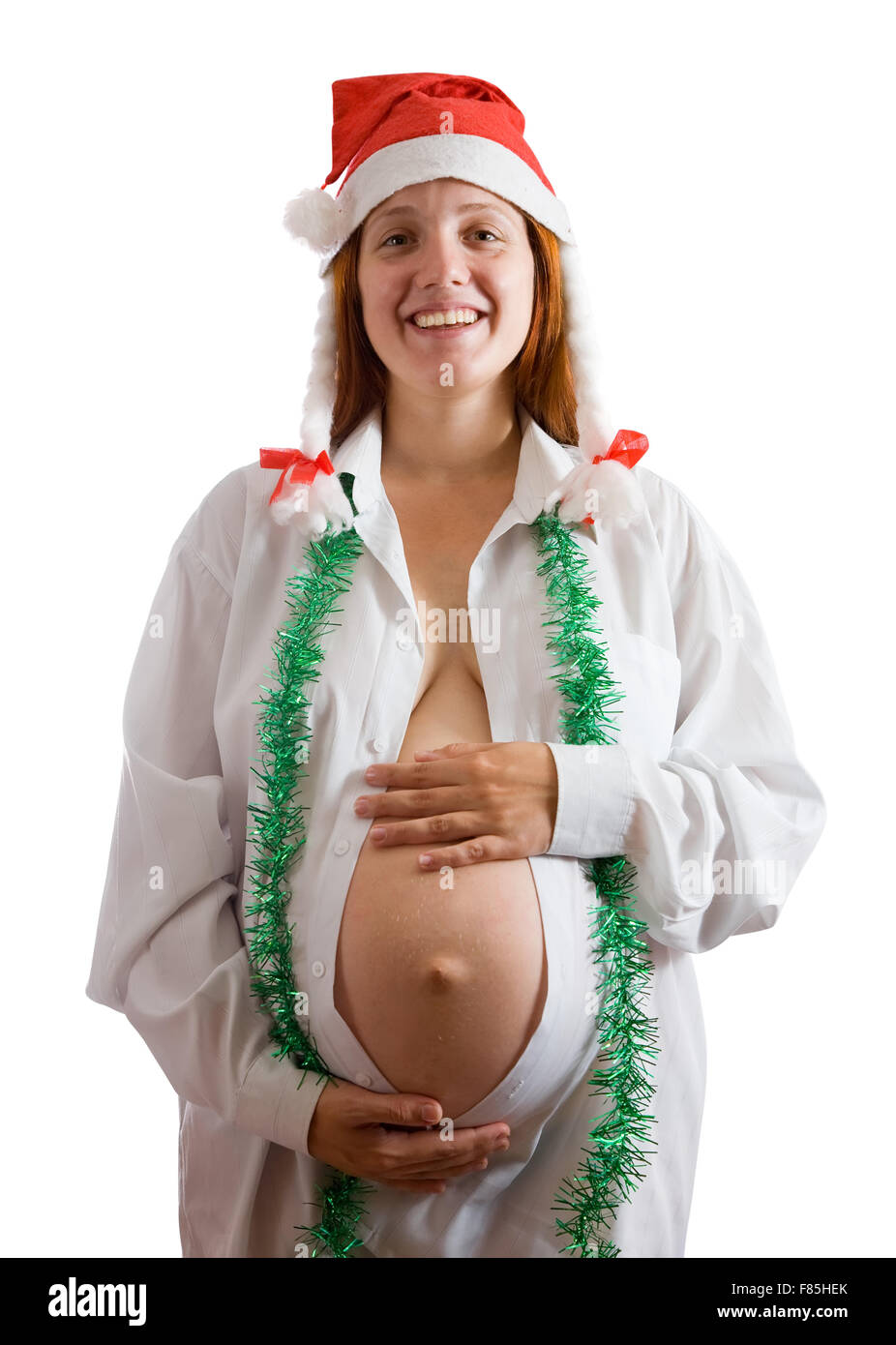 Schwangere Frau in Weihnachten Kleidung über weiß Stockfoto
