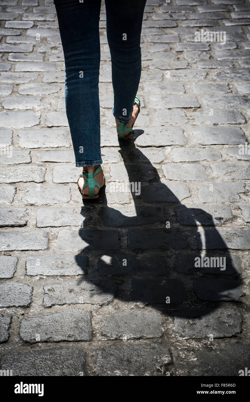 Nahaufnahme einer jungen Frau zu Fuß auf einer gepflasterten Straße Stockfoto