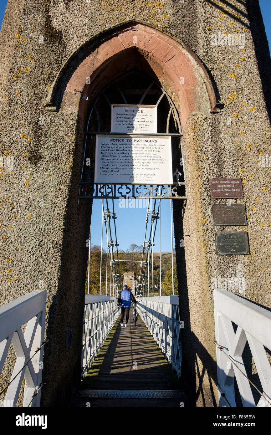 Man treibt ein Fahrrad am südlichen Hochland über kettenbrücke Fußgängerbrücke über den Fluss Tweed. Melrose Scottish Borders Schottland Großbritannien Stockfoto