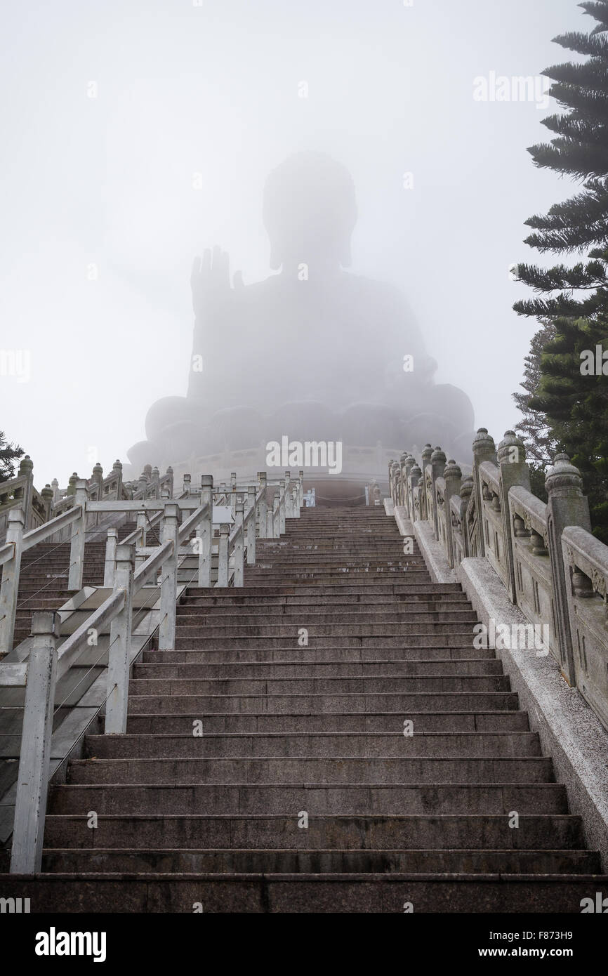 Leere Treppe zum nebligen Tian Tan Buddha oder Big Buddha Statue auf Lantau Island, Hong Kong, China. Ansicht von unten. Stockfoto