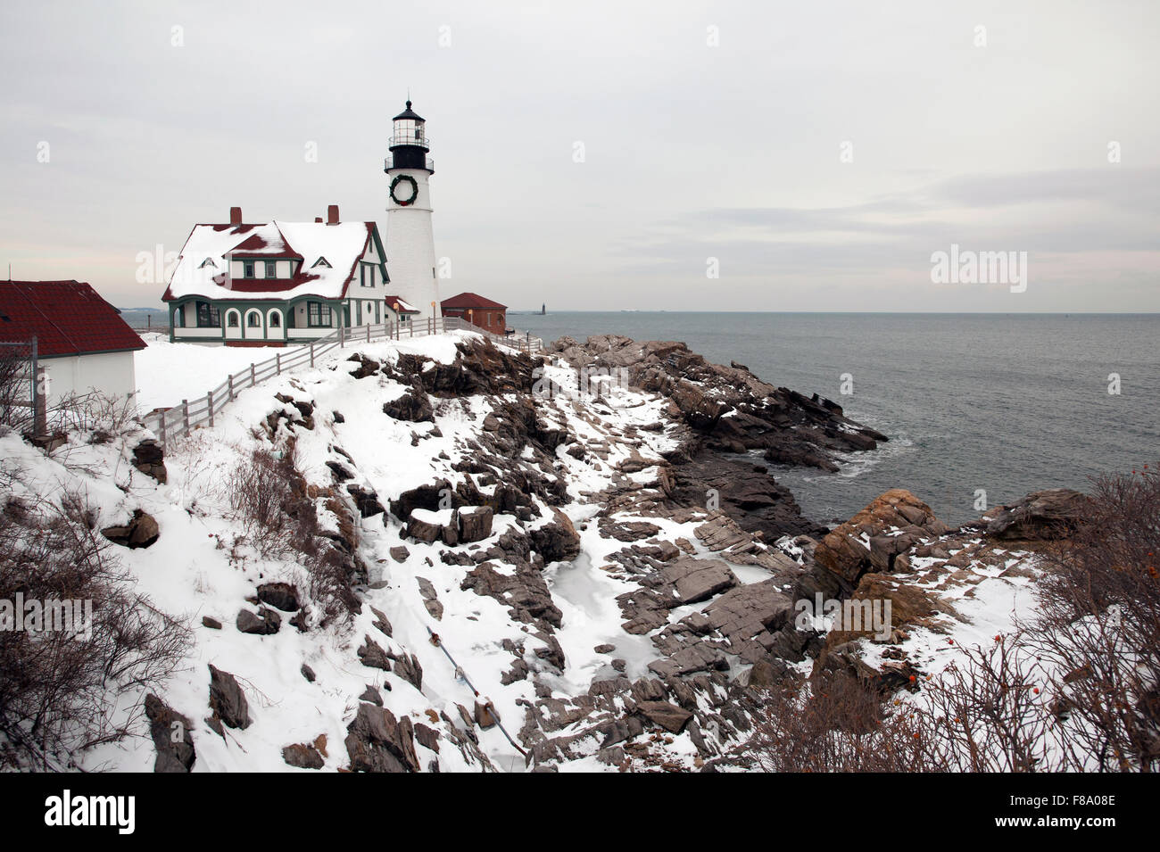 Ein großer Kranz ist auf Portland Head Lighthouse hing die Weihnachtszeit an der felsigen Küste zu feiern. Es ist das älteste Leuchtfeuer in Maine. Stockfoto