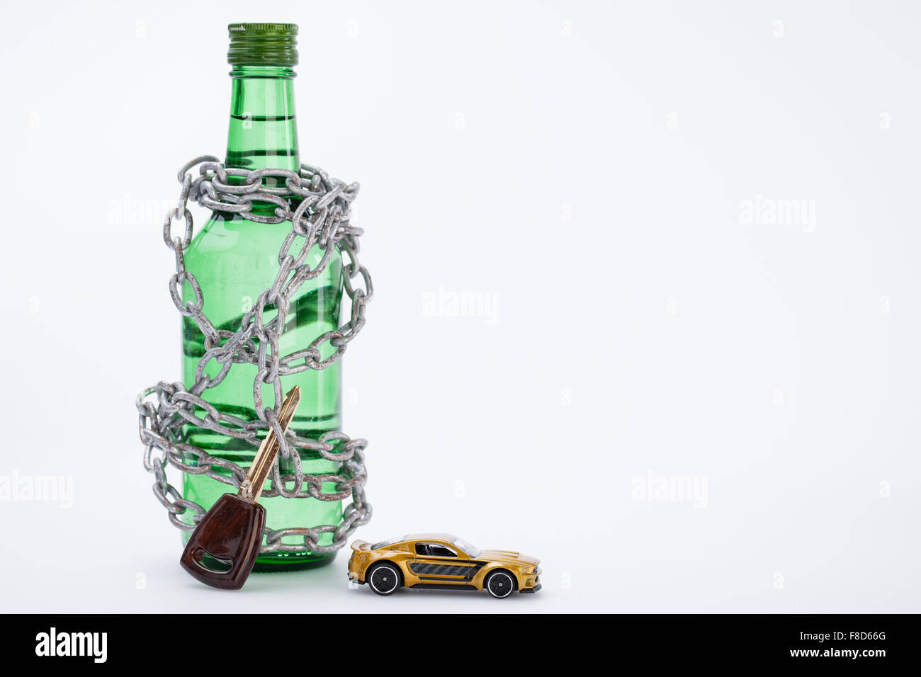 Alkohol Flasche mit einem Autoschlüssel und ein Miniatur-Auto in Ketten gehalten. Stockfoto