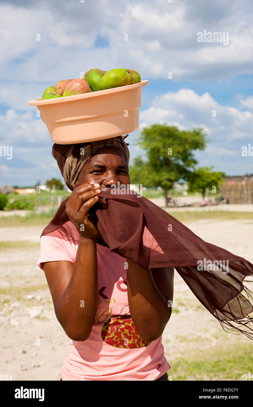 Afrikanische Frau, die die Früchte auf dem Kopf in Botswana Stockfoto