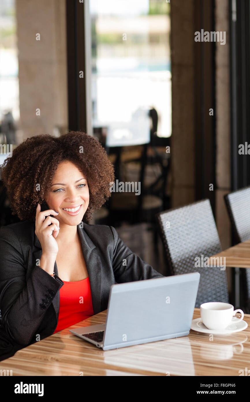 Gemischte Rassen Frau am Handy im café Stockfoto