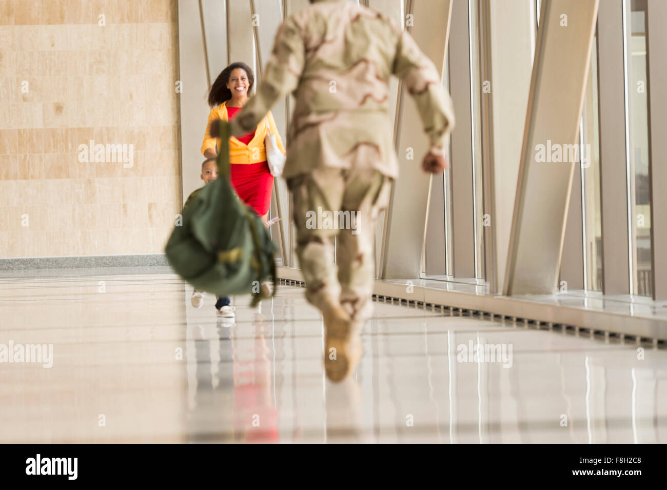 Afrikanische amerikanische Soldat Gruß Frau am Flughafen Stockfoto