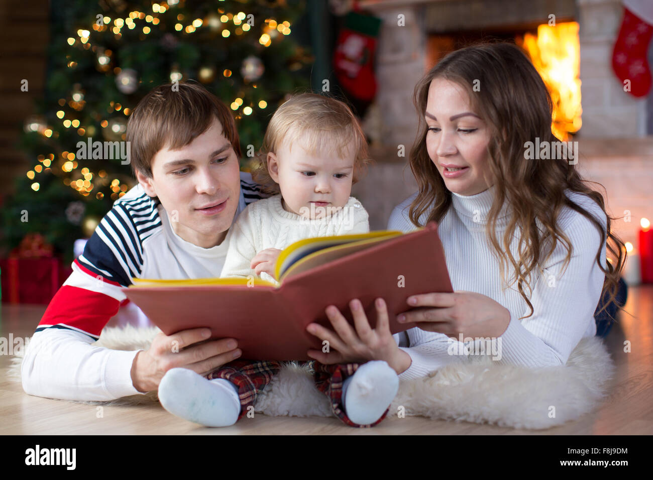 Familie zusammen am Heiligen Abend lesen Stockfoto