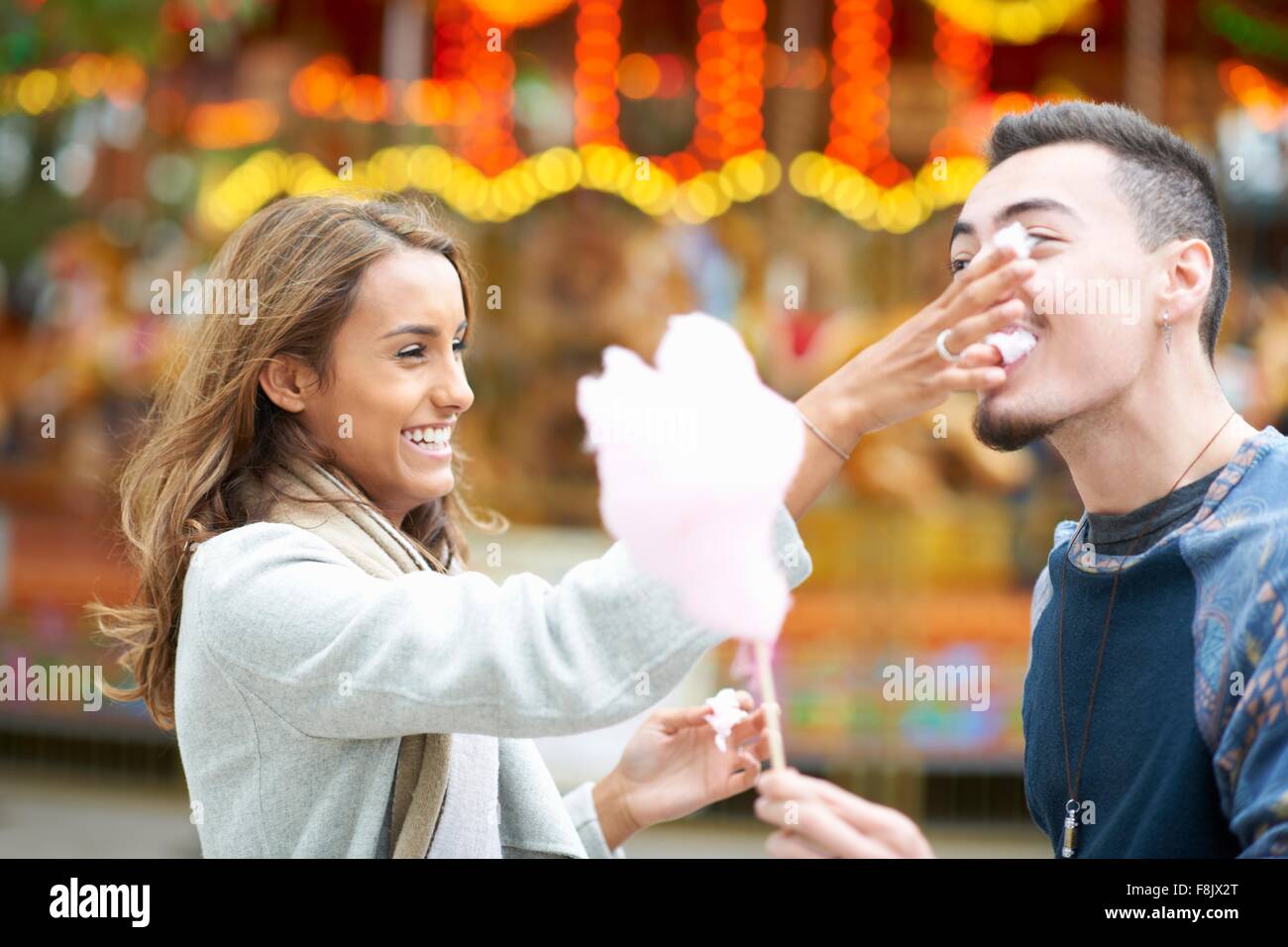 Junges Paar, herumalbern, Zuckerwatte essen, Jahrmarkt, im freien Stockfoto
