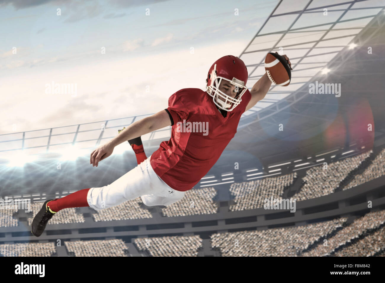 Zusammengesetztes Bild des american-Football-Spieler mit einen touchdown Stockfoto