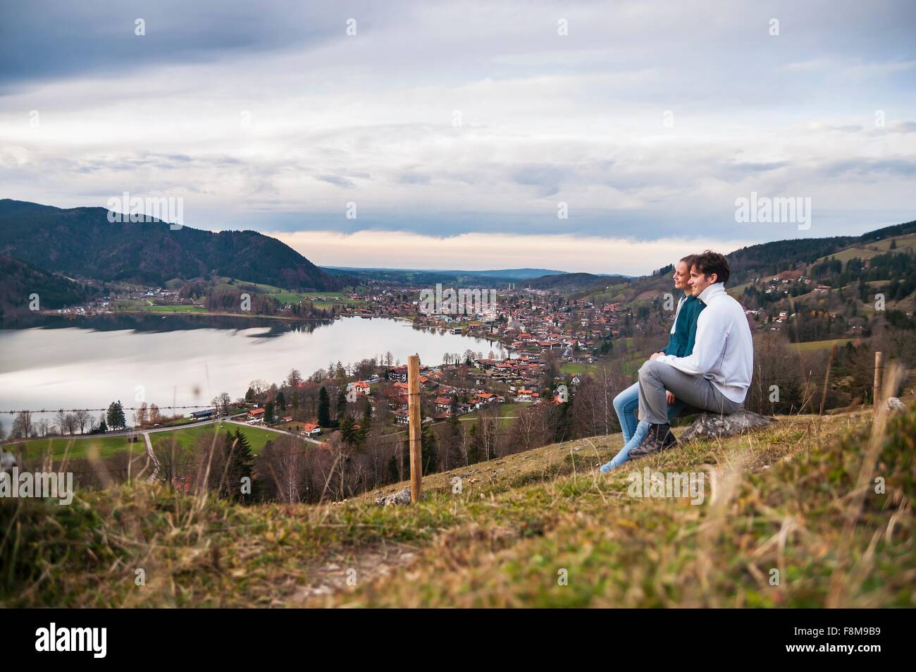 Seitenansicht des paar sitzen, Blick auf See, Schliersee, Bayern Stockfoto