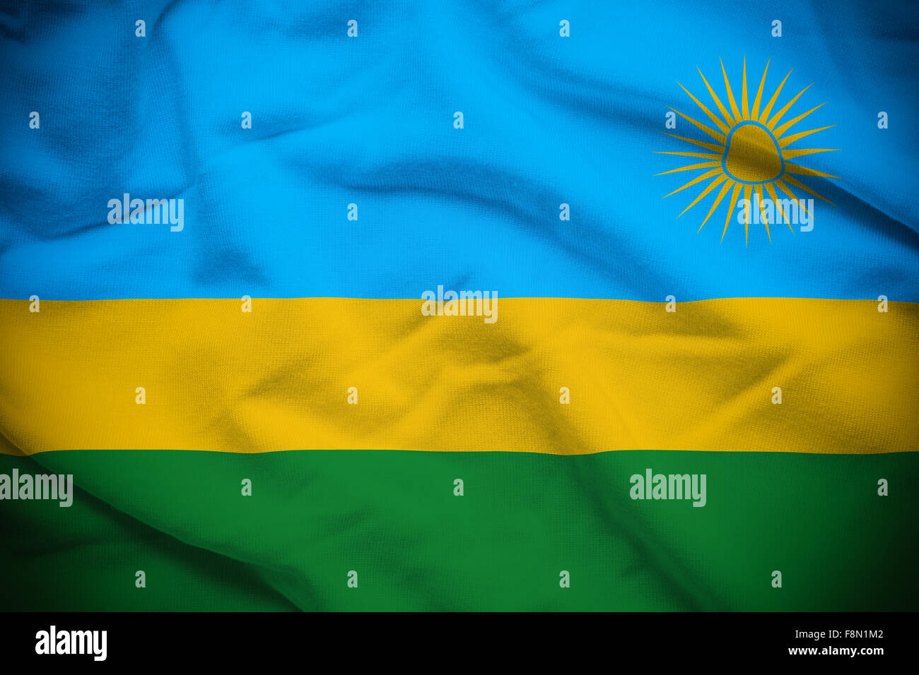 Wellig und wellige Nationalflagge Ruanda Hintergrund. Stockfoto