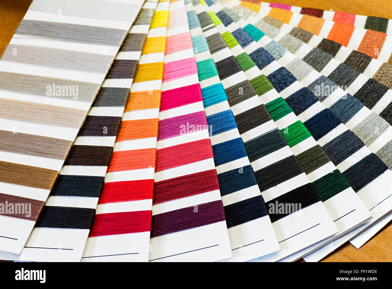 Textile Stillleben Hintergrund - Baumwolle Thread Farbmuster aufgefächert in bunten Array Stockfoto