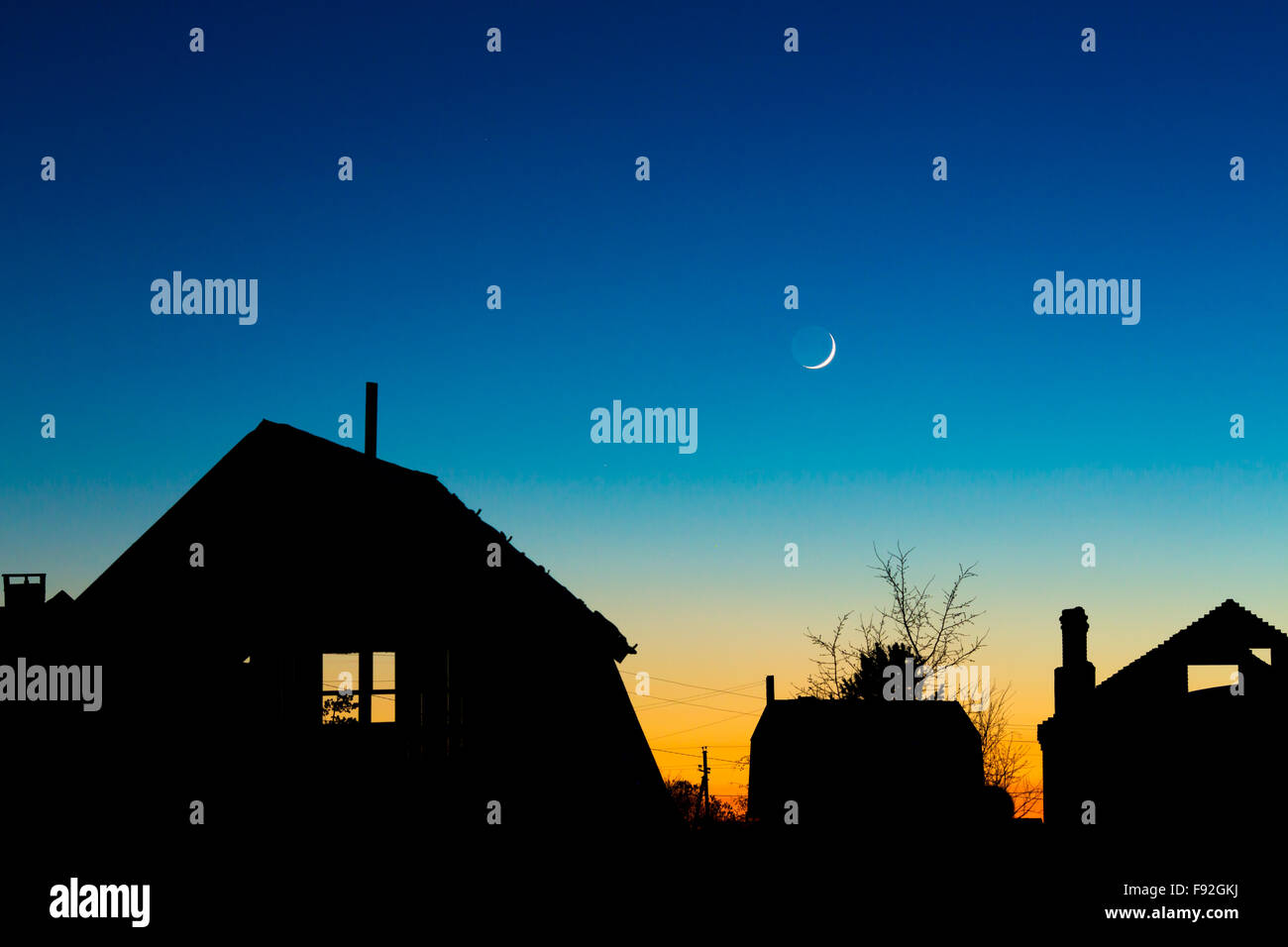 Dächer-Silhouetten gegen den Nachthimmel mit Neumond Stockfoto
