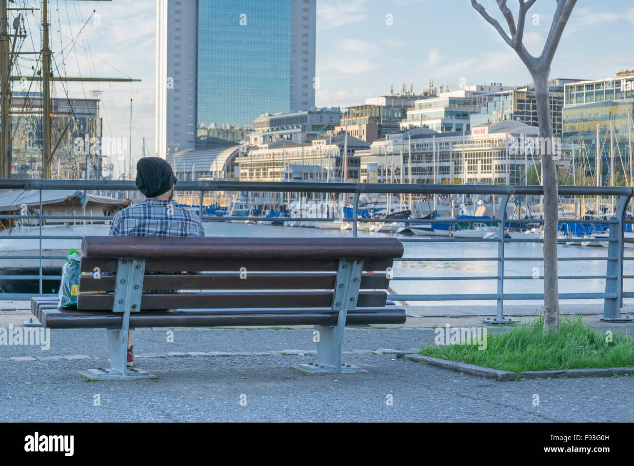 Rückansicht des Jünglings auf Holz Stuhl an der Promenade von Puerto Madero in Buenos Aires, Argentinien Stockfoto