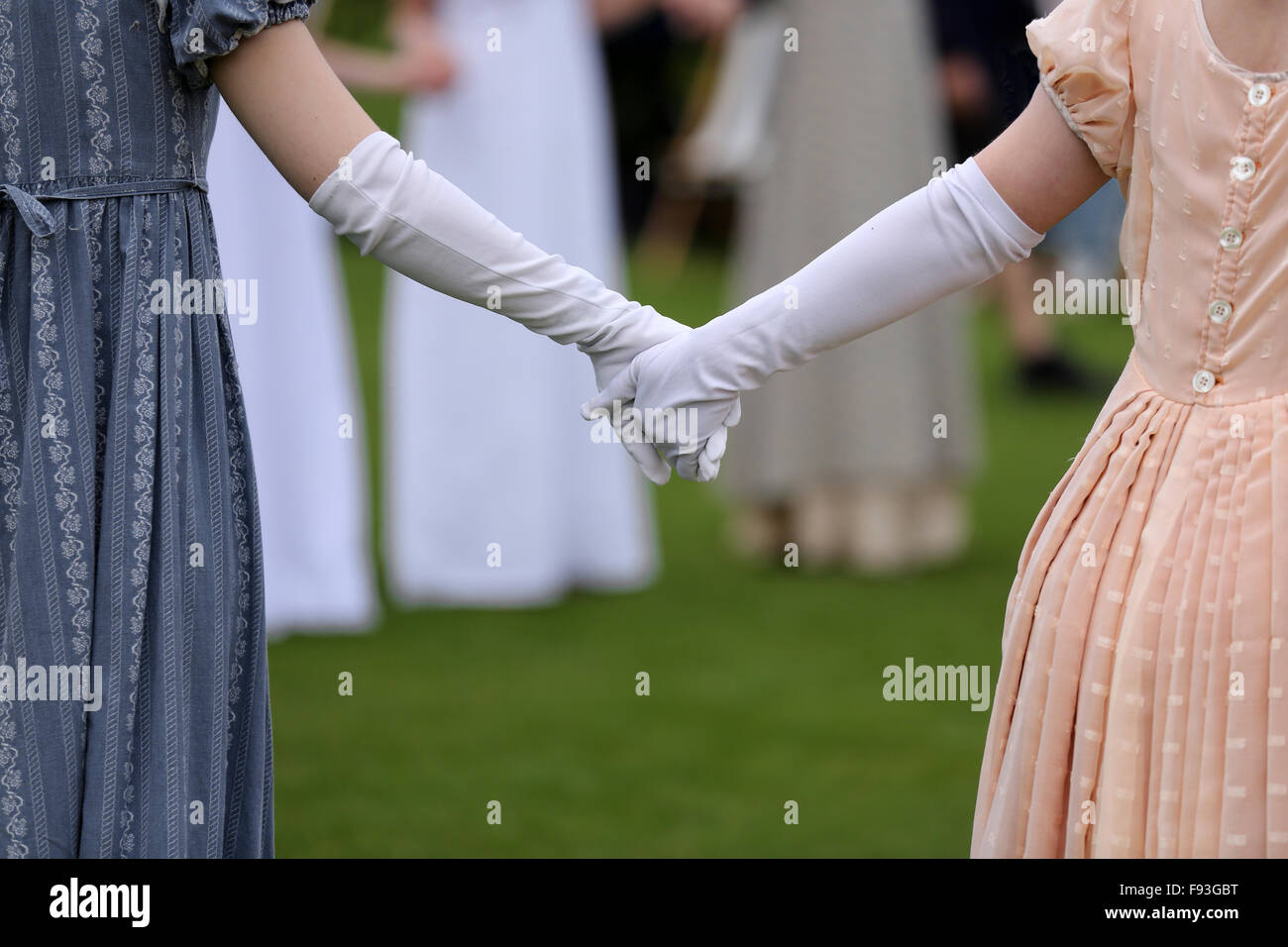 Behandschuhten junge Frauen Hand in Hand in historischen Kostümen aus dem 18. Jahrhundert. Stockfoto