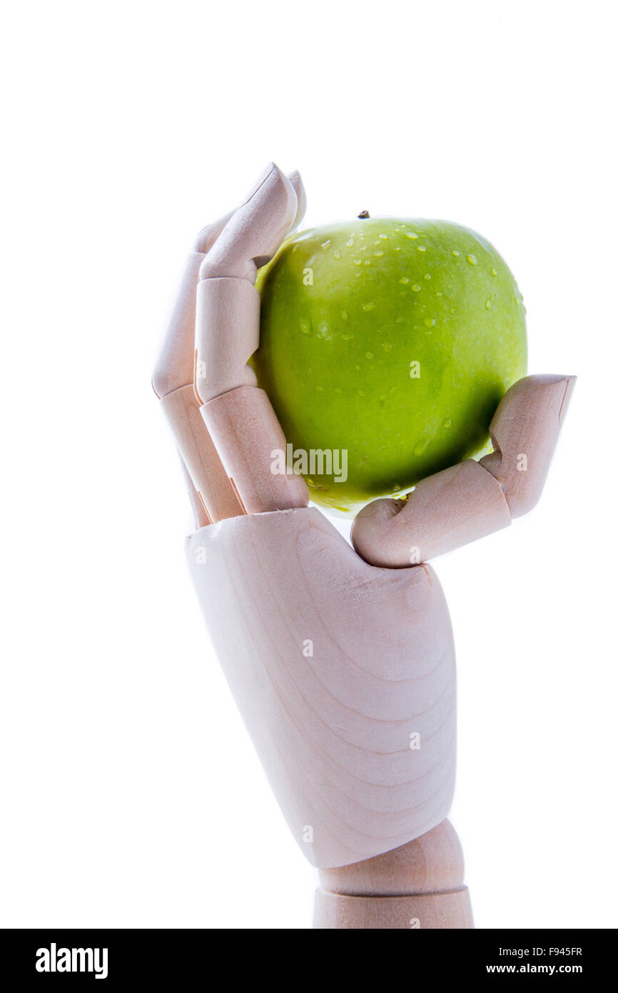 Hölzerne Hand hält einen Apfel auf weißem Hintergrund Konzept für Süßstoff Stockfoto