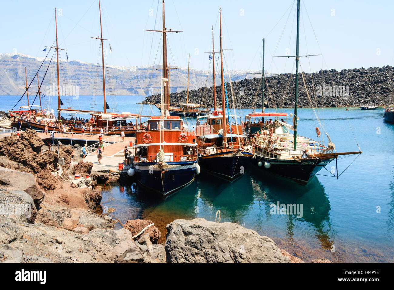 Santorini. Erinia Bay, Nea Kameni. Ausflug Boote am Steg vertäut verpackt mit Massen von Touristen Ein- und Aussteigen auf dem Vulkan besuchen. Stockfoto Santorini. Erinia Bay, Nea Kameni. Ausflug Boote am Steg vertäut verpackt mit Massen von Touristen Ein- und Aussteigen auf dem Vulkan besuchen. Stockfoto