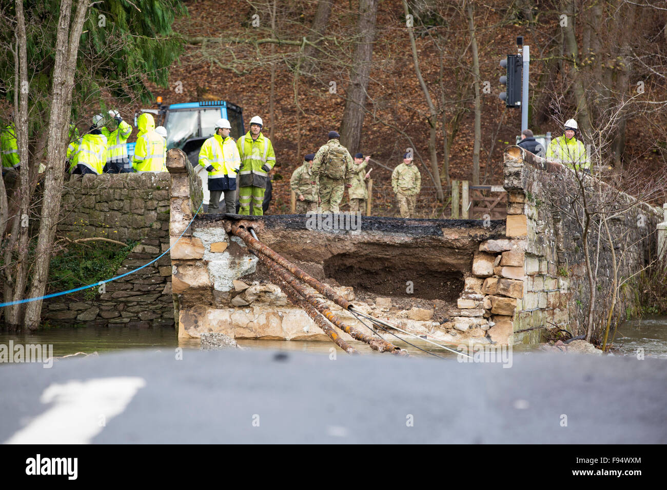 Pooley-Brücke, die den Fluss Eamont unter Ullswater überspannt hatten die Elemente standgehalten, da wurde es im Jahre 1764 gebaut, aber es war kein Spiel für Sturm Desmond und wurde völlig zerstört. Foto auf Dienstag, 8. Dezember 2015, mit British Telecom Ingenieure versuchen, Kommunikation auf die andere Seite wiederherstellen, nachdem sie durch den Brückeneinsturz, zusammen mit Soldaten der britischen Armee geschnitten wurden. Der Sturm setzen einen neuen britischen Rekord für Rainfsll Summen an einem Tag mit 341,4 mm in 24 Stunden fallen. Stockfoto