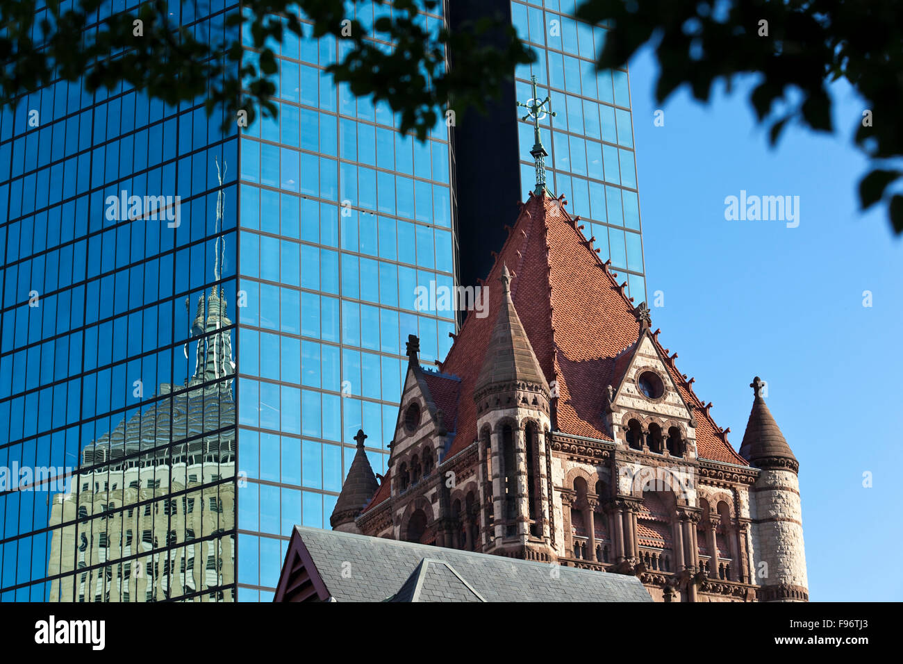 Im Vordergrund ist der zentrale Turm von Boston Trinity Church, a nationaler historischer Grenzstein befindet sich am Copley Square an der Stockfoto