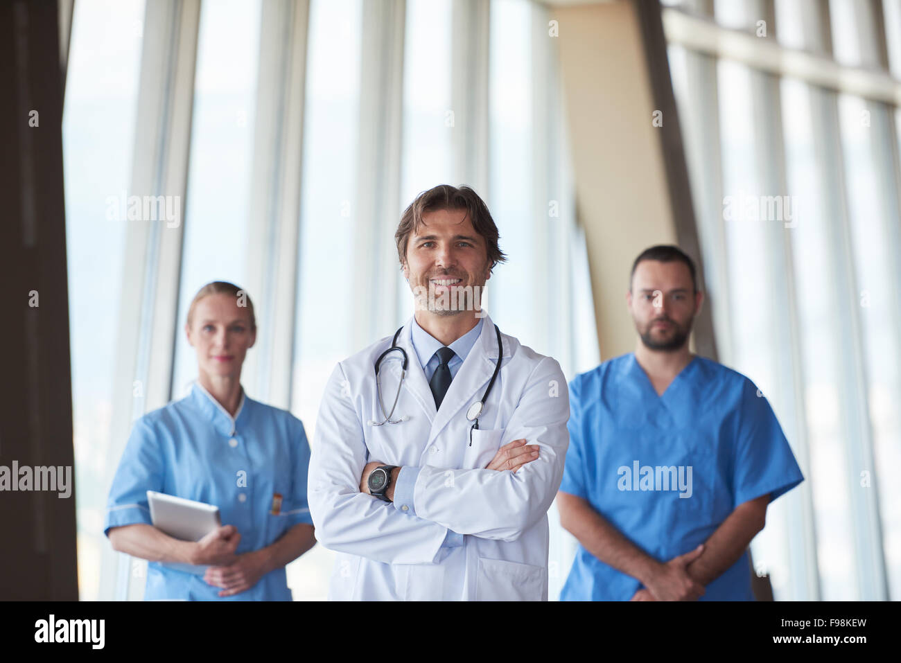 group of medical staff at hospital, handsome doctor in front of team, people group  standing together in background Stockfoto