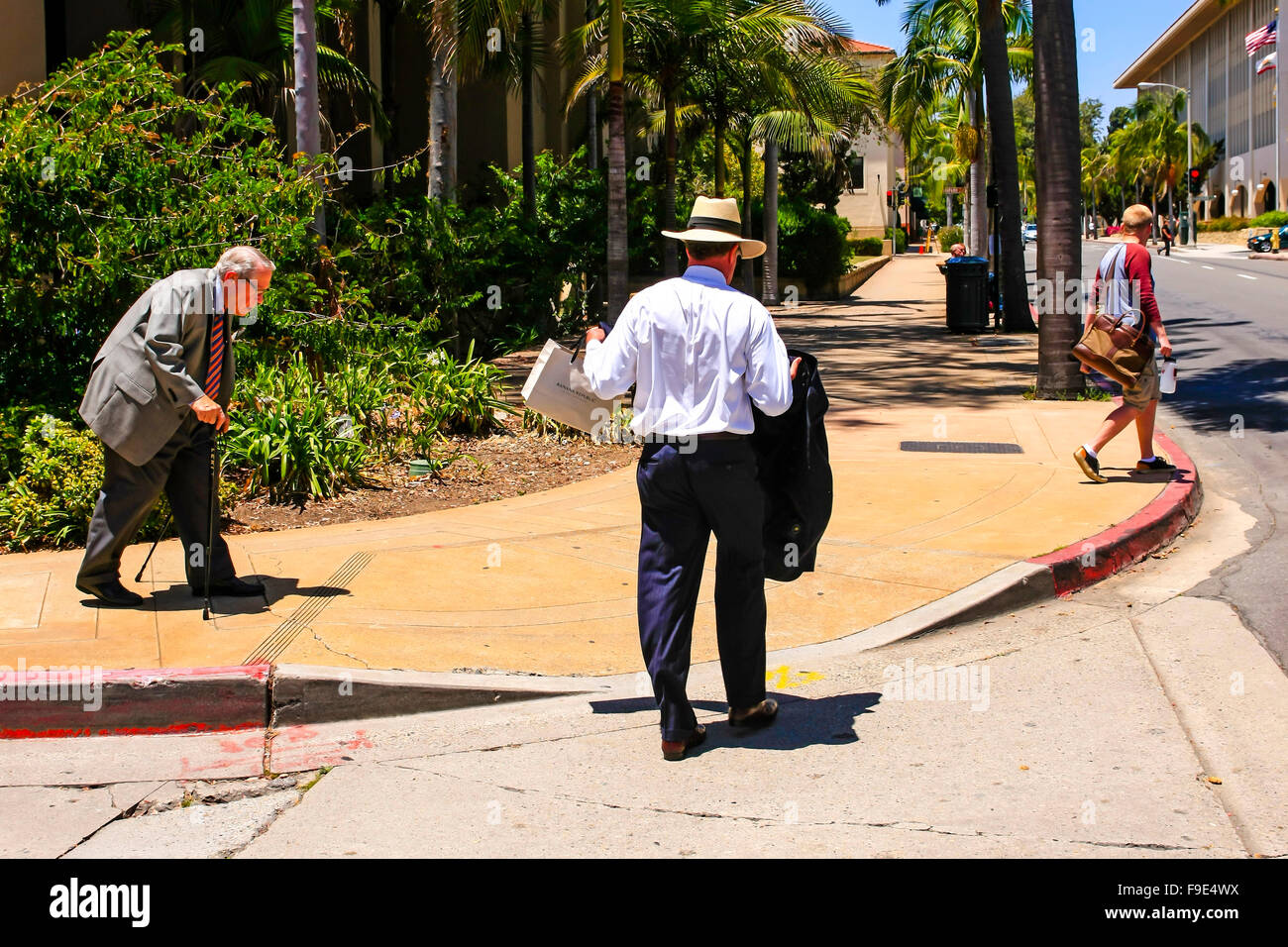 Männer tragen unterschiedlicher Kleidung aus Shorts und T-shirt zu einem Anzug und Panamahut in Santa Barbara, Kalifornien Stockfoto