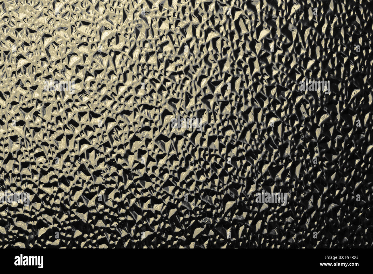 Gewellte Oberfläche aus Glas getönt gold Farbe Foto Stockfoto