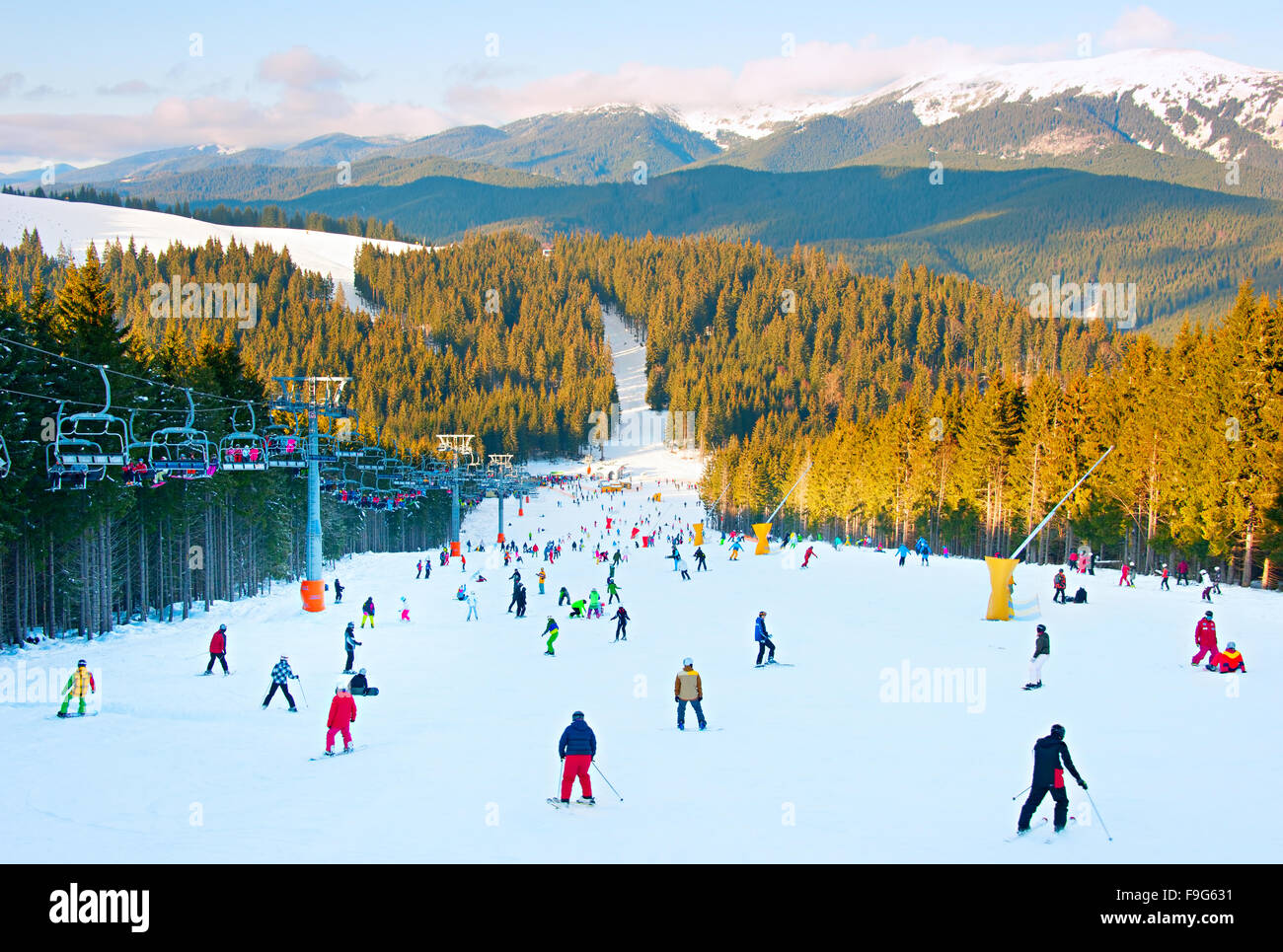 Menschen, Skifahren und Snowboarden am Hang im Skigebiet Stockfoto