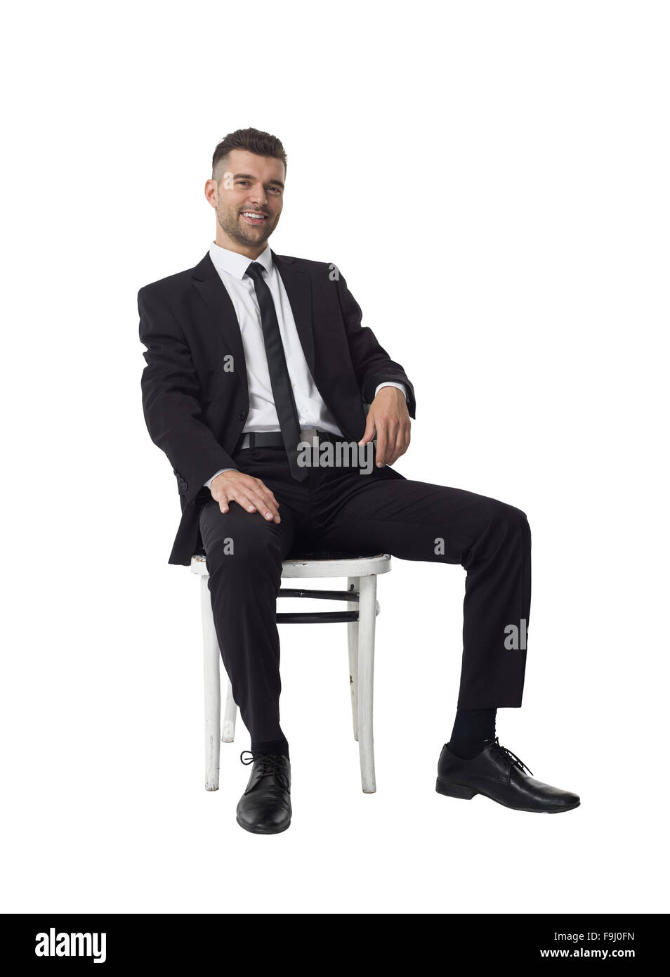 Geschäftsmann, sitzen auf Stuhl Full Length Portrait isoliert auf weißem Hintergrund Stockfoto