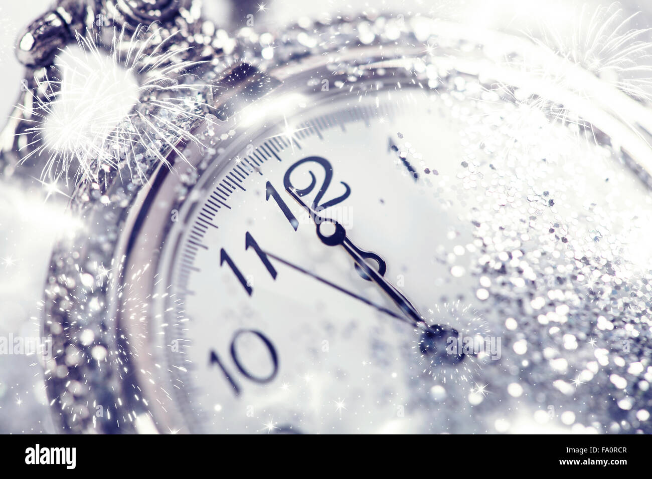 Silvester um Mitternacht - alte Uhr mit Sternen, Schneeflocken und Weihnachtslichter Stockfoto