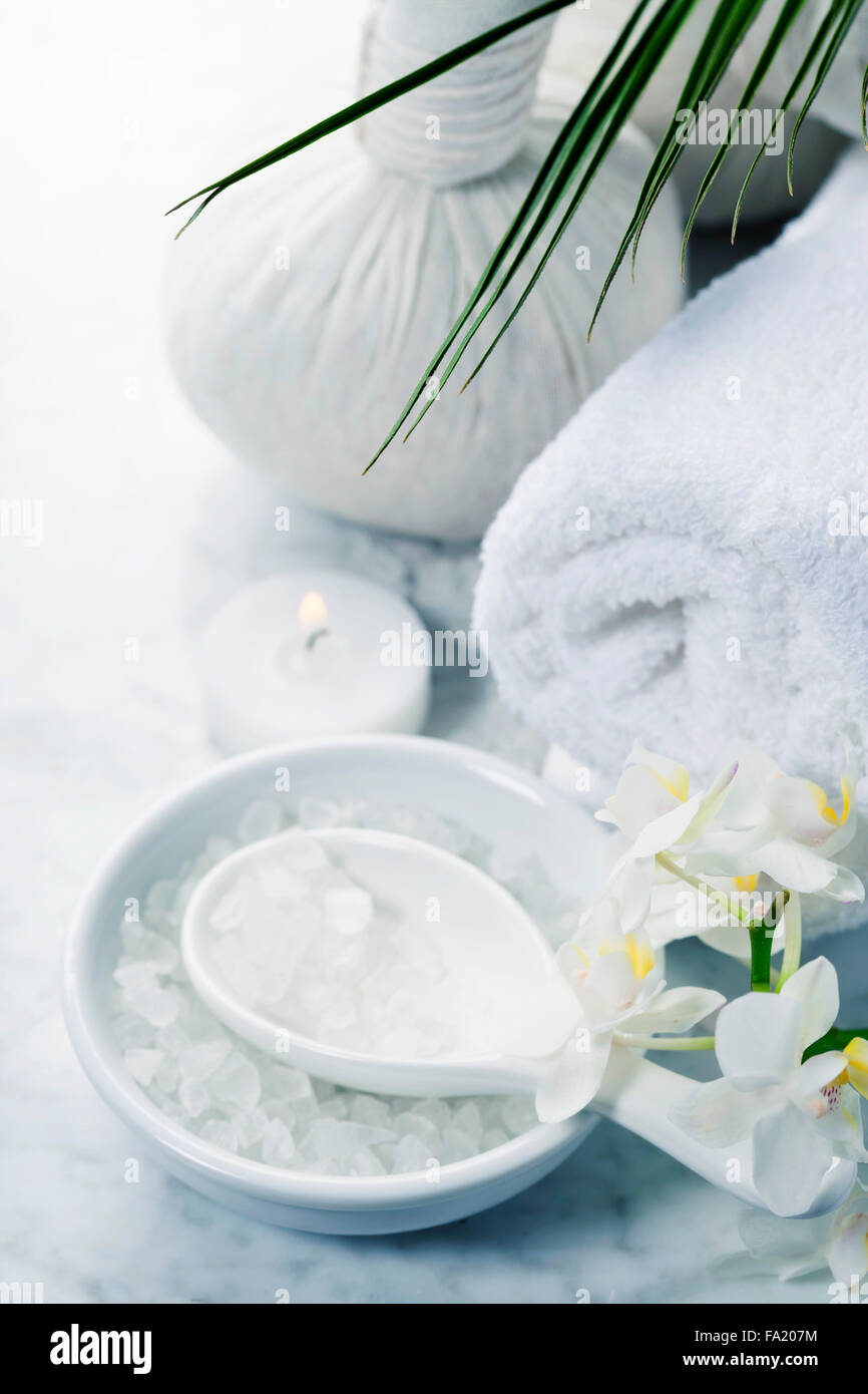 Spa-Hintergrund (weiße Orchidee, pflanzliche Kompresse Briefmarken, Meersalz, Handtuch- und massage-Steinen) Stockfoto