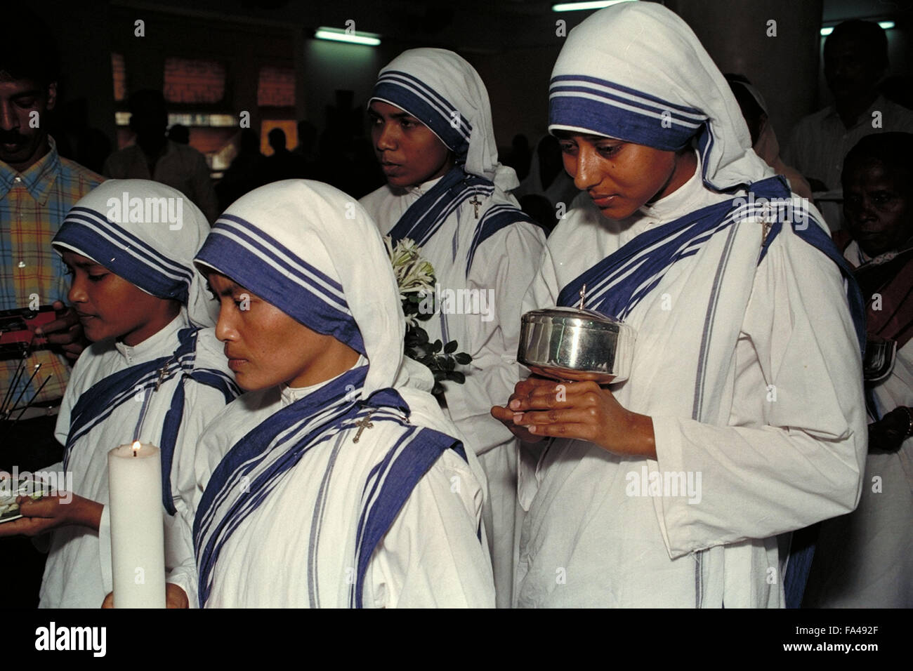 Vier Mitglieder der Missionarinnen der Nächstenliebe bringen Geschenke zum Altar nach Messe in St. Marien Kirche in Kolkata, Indien Stockfoto