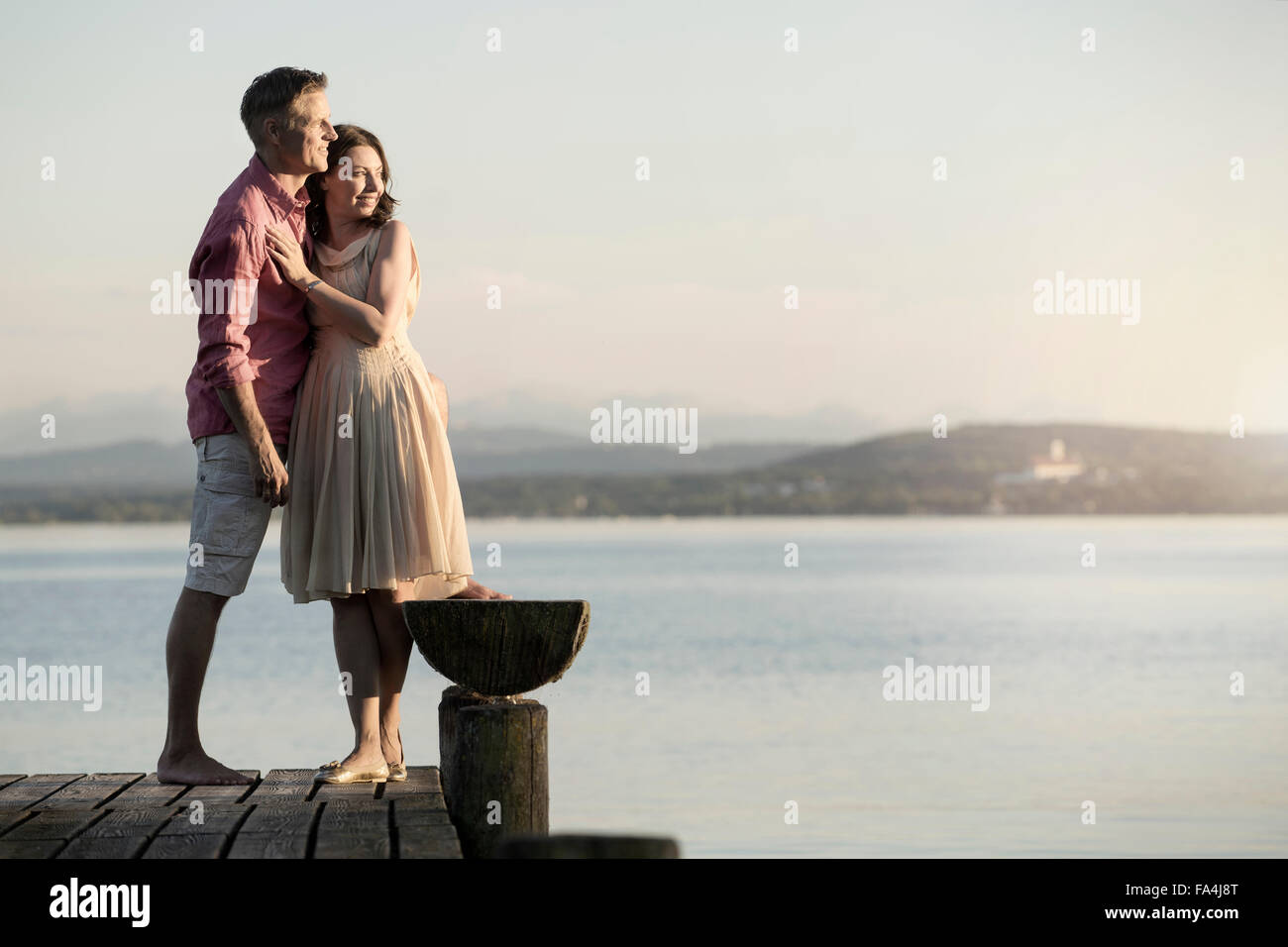Älteres Paar auf Pier mit Blick auf See, Bayern, Deutschland Stockfoto