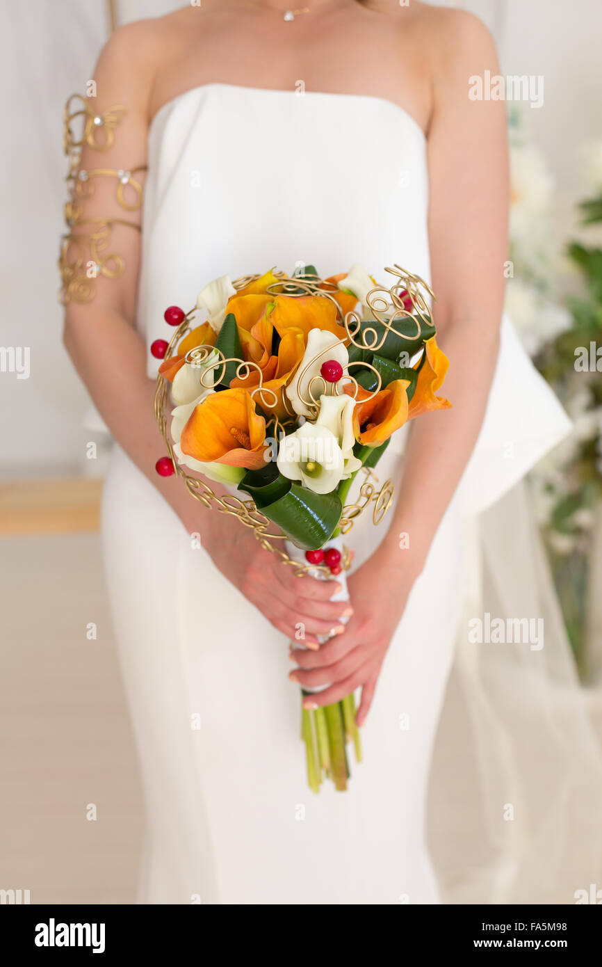 Braut Hochzeit Bouquet mit Hagebutten, Smokebush und gelbe Calla Lilien hält Stockfoto