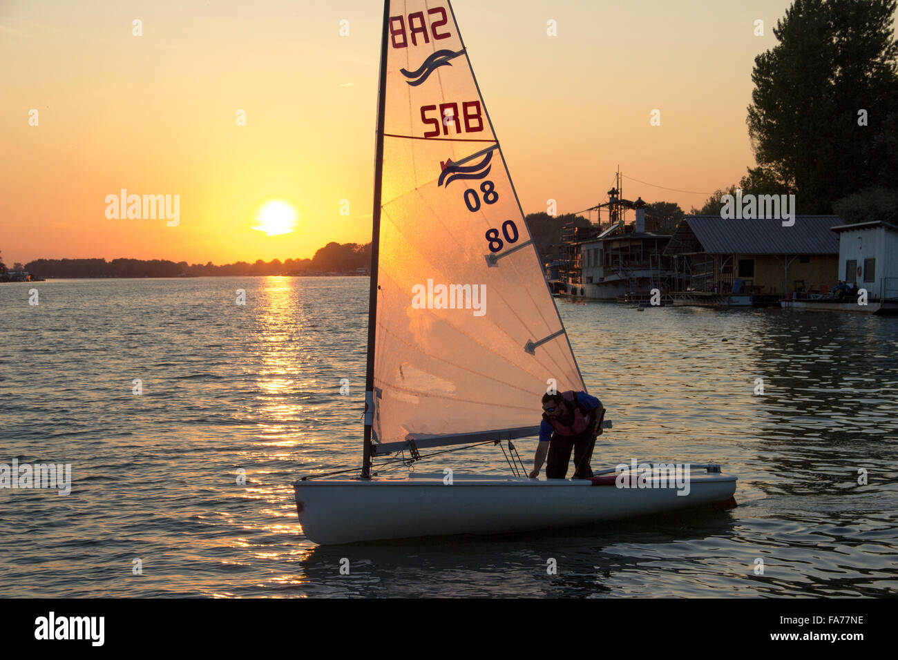 Belgrad, Serbien - Finn-Klasse Yacht Segeln bei Sonnenuntergang Stockfoto