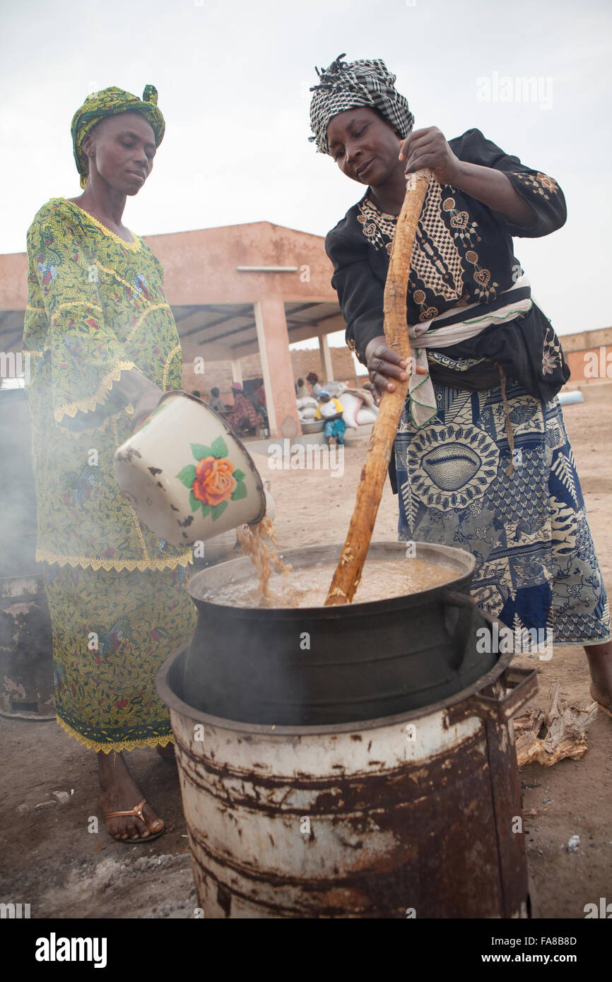 Reis ist parboiled, vor dem Verkauf an eine Gruppe Verarbeitung Frauenzentrum in Sourou Provinz, Burkina Faso. Stockfoto