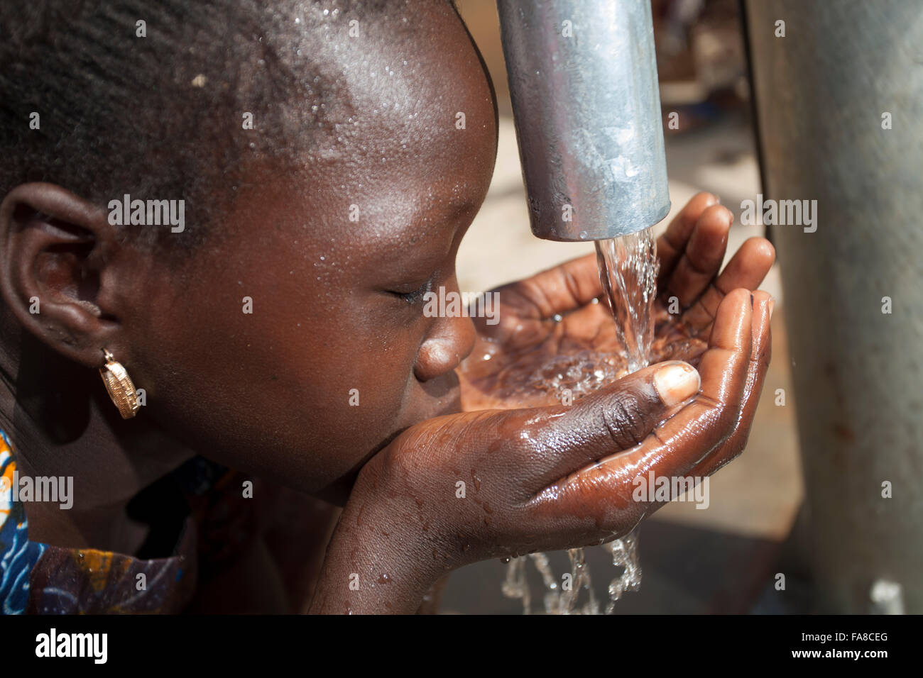Mädchen bekommen frisches Wasser aus einem Brunnen in Kouka Abteilung in Burkina Faso, W. Afrika. Stockfoto