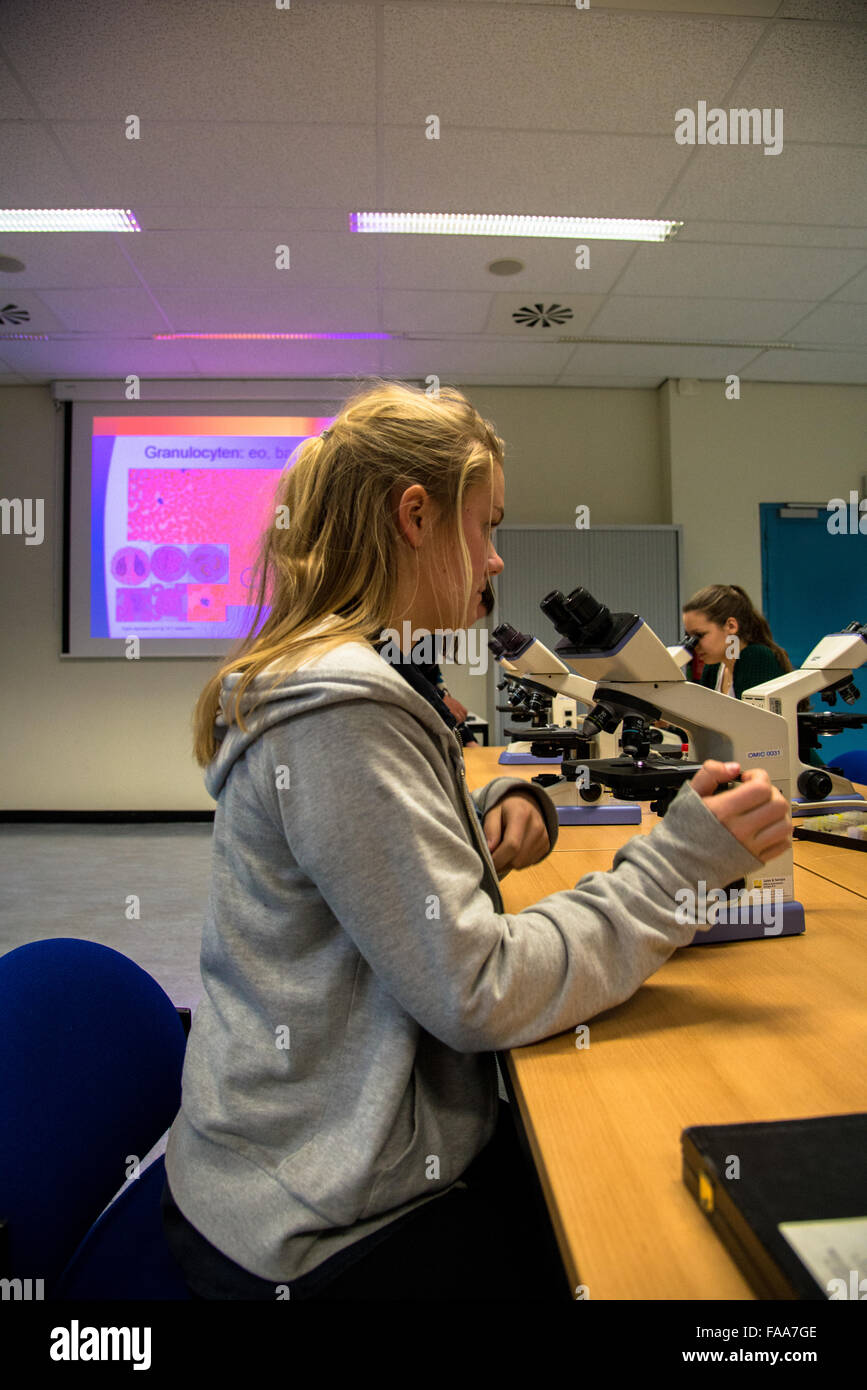 Student mit Mikroskop an der Universität Stockfoto