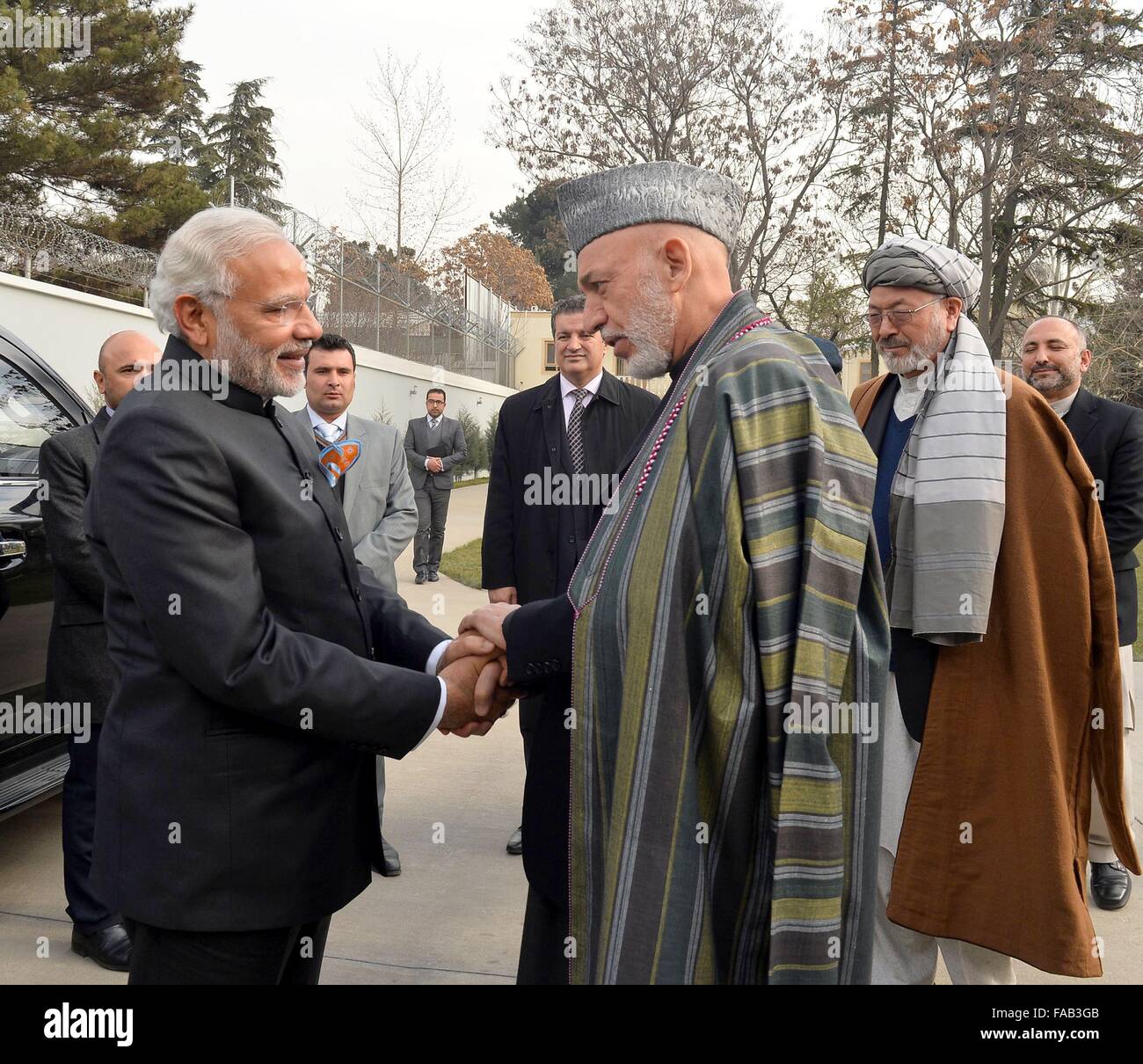 Kabul, Afghanistan. 25. Dezember 2015. Der indische Premierminister Narendra Modi, links, wird vom ehemaligen Präsidenten Afghanistans Hamid Karzai, rechts, bei seiner Ankunft am 25. Dezember 2015 in Kabul, Afghanistan. Modi hielt auf dem Heimweg von einem Besuch in Moskau in Afghanistan an. Stockfoto