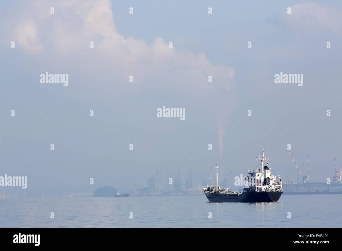 Frachter Frachtschiff gegen trübe blauen Himmel Stockfoto