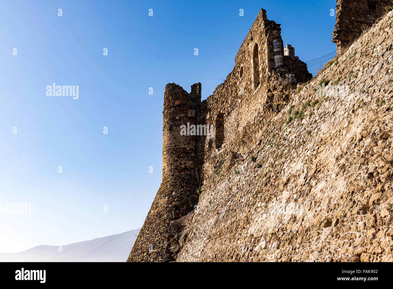 Die Sonne geht auf einer Burgmauer in der spanischen Landschaft. Stockfoto