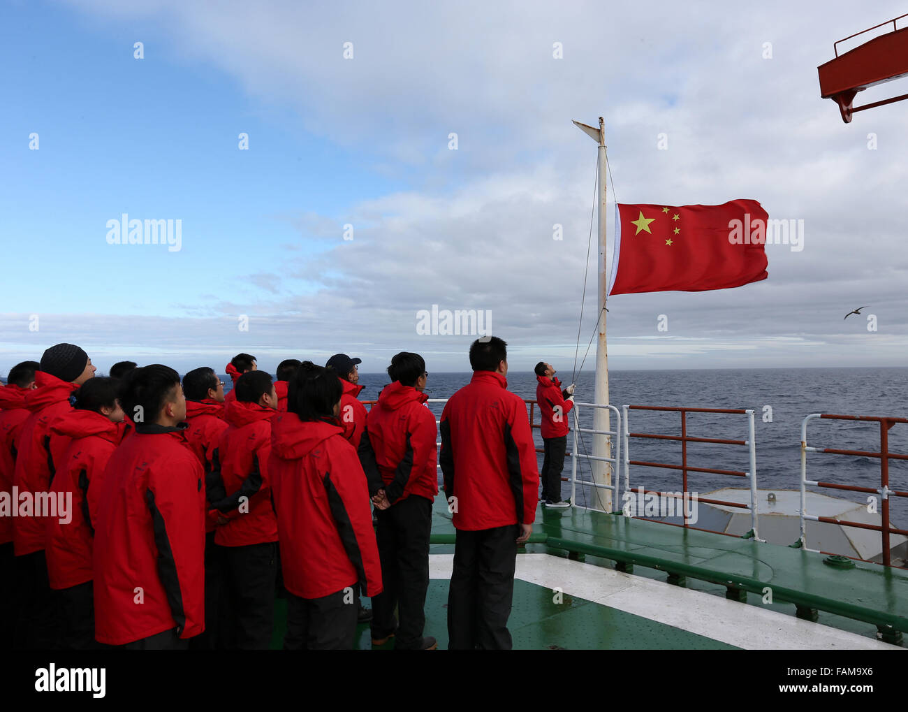 (160101)--Xuelong, 1. Januar 2016 (Xinhua)--Mitglieder der chinesischen wissenschaftlichen Expeditionsteam den Aufstieg der nationalen Flagge zu sehen und gab einen neues Jahr Gruß an Bord Chinas Eisbrecher Xuelong (Snow Dragon) in der Antarktis, 1. Januar 2016. (Xinhua/Zhu Jicha) (Cxy) Stockfoto